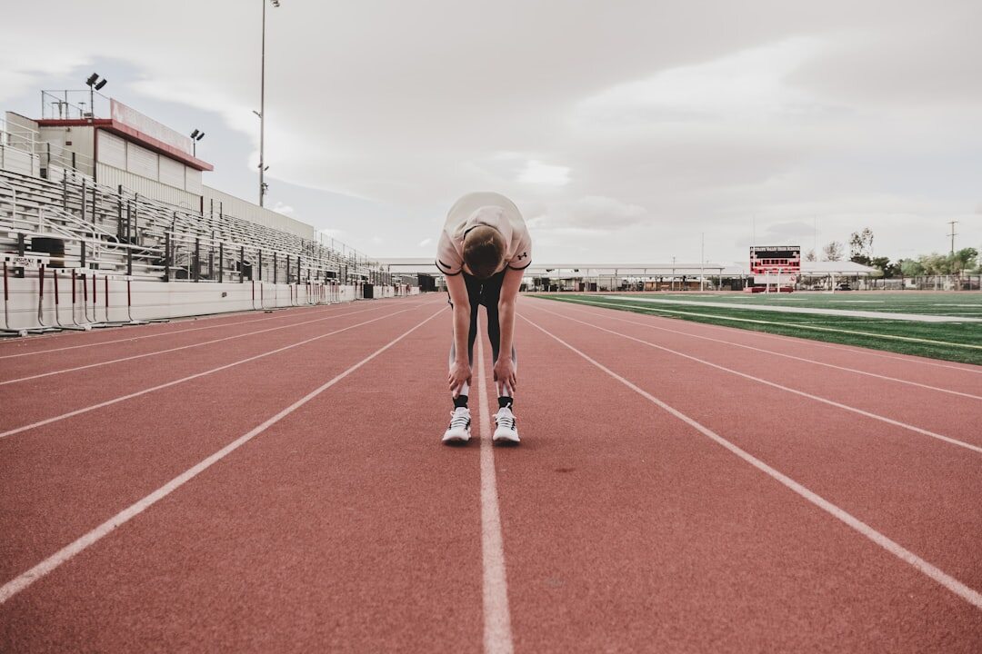 athlete running on track